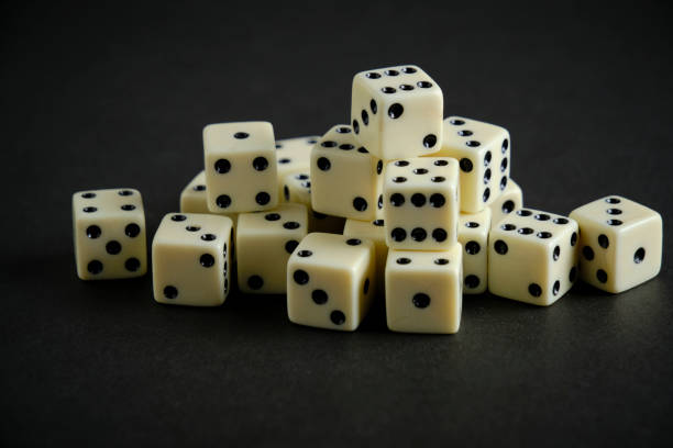 istock Bunch of ivory dice on black background. 1495091662