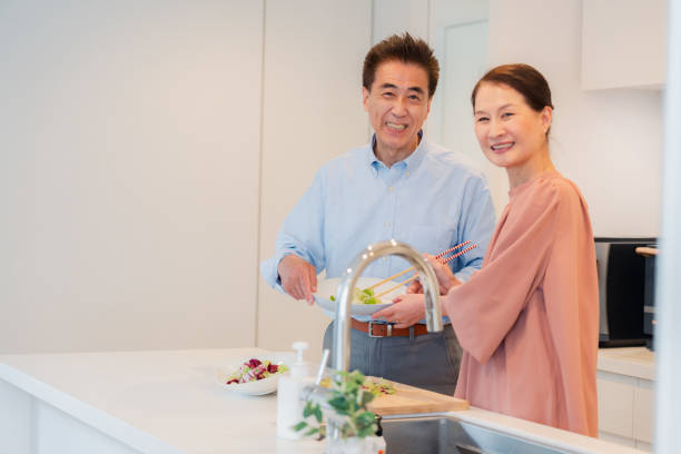 istock Senior couple enjoying cooking together in the kitchen 1495091717