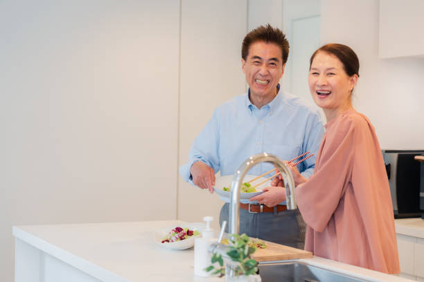 istock Senior couple enjoying cooking together in the kitchen 1495091756