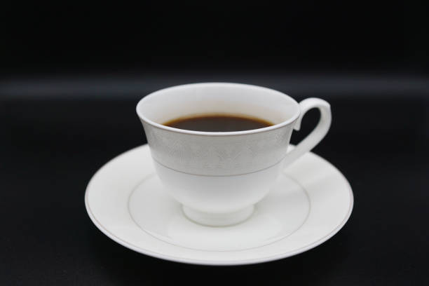 ceramic cups stacked against a dark background with dim light