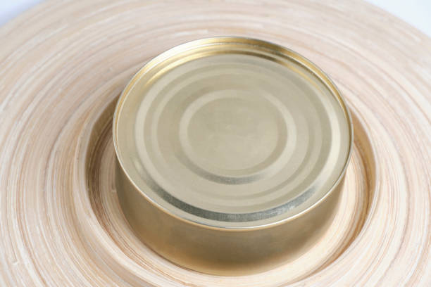 istock Closed tin can on wooden background. 1495093387