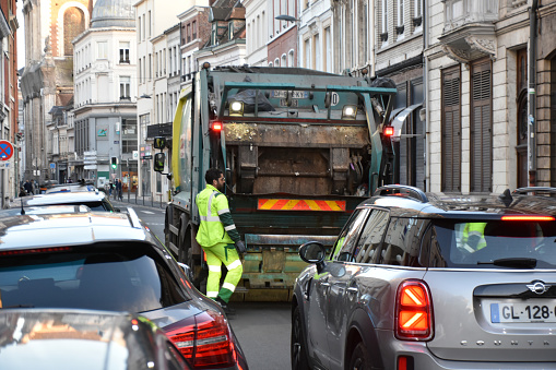 Refuse Collectors Loading Garbage Into Garbage Truck, Building Exterior, Land Vehicle, Road Traffic, Retail Store Scene In Lille France Europe