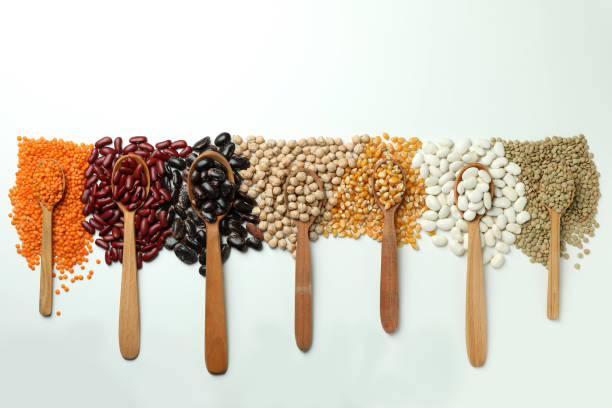 istock Spoons with different types of beans on white background 1495094083