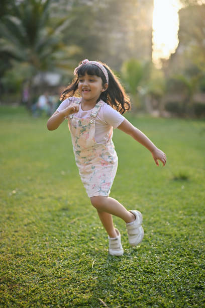 istock Cute Girl running amidst a public park during sunset 1495094271