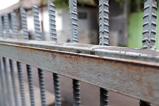 a rusty gray iron fence