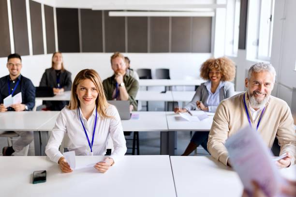 istock Smiling people attending business training in the bright modern office 1495097114