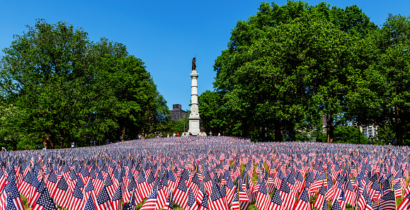 Boston, Massachusetts, USA - May 29, 2023: Memorial Day Flag Garden in front of the the Soldiers and Sailors Monument on the Boston Common. Thirty seven thousand American flags for annual U. S. Memorial Day celebration.