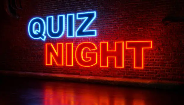 Quiz Night. Text in orange and blue illuminated letters. Brickwall in the background. Leisure games, game night, activity, entertainment event, bingo, quiz night and playing.