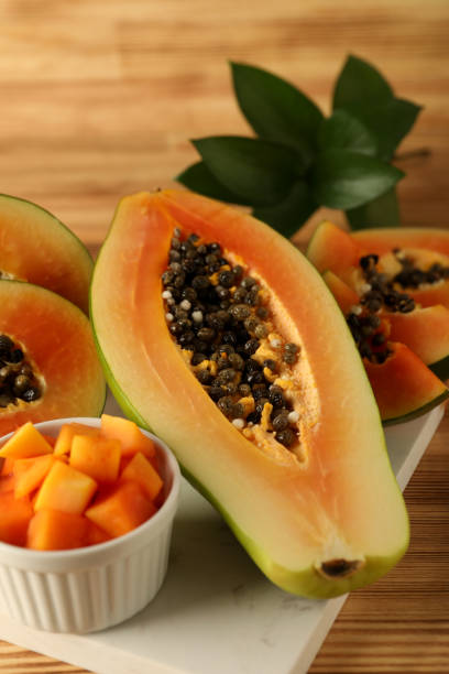 istock Fresh ripe papaya on light wooden table 1495100866