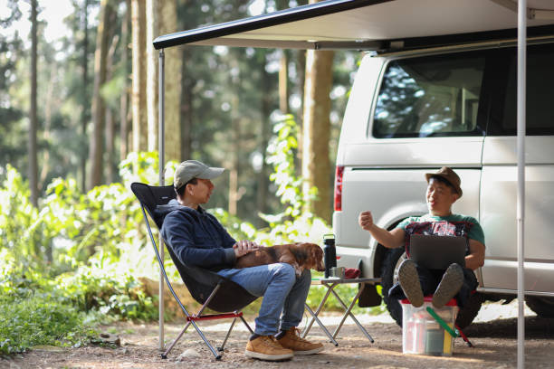 istock Two men driving a camper van to a high mountain enjoying the tranquility in the forest 1495103809