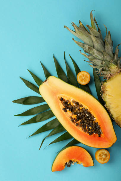 istock Ripe fresh exotic fruits on blue background 1495105910