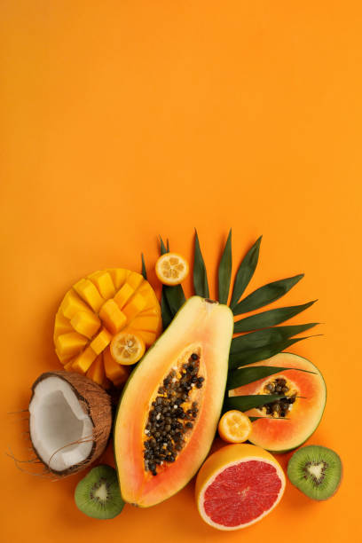 istock Exotic fruits set on orange background, space for text 1495106060