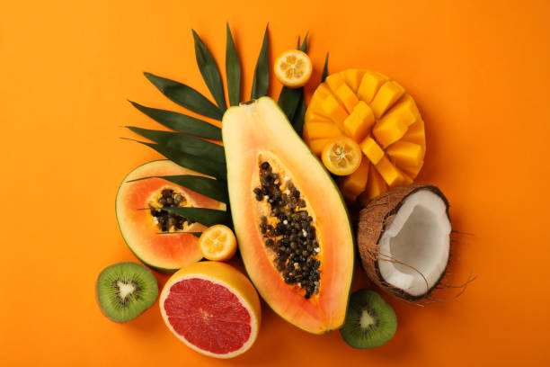istock Exotic fruits set on orange background, top view 1495106109