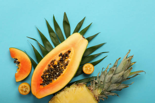 istock Ripe fresh exotic fruits on blue background 1495106163