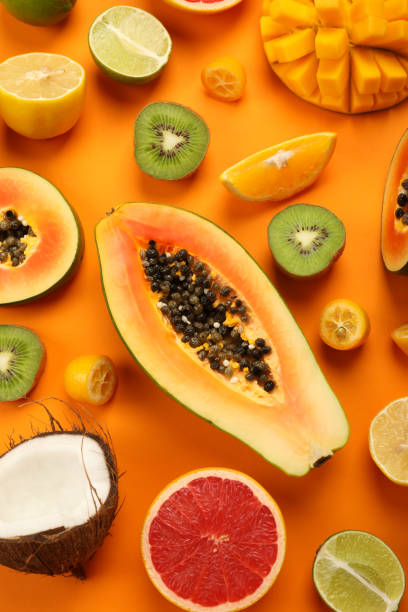 istock Exotic fruits set on orange background, top view 1495106346