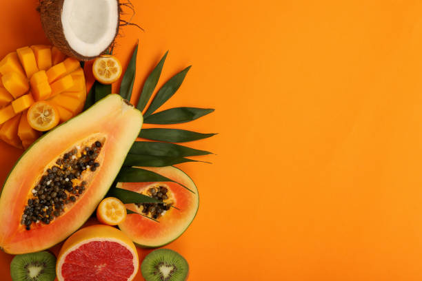 istock Exotic fruits set on orange background, space for text 1495106722
