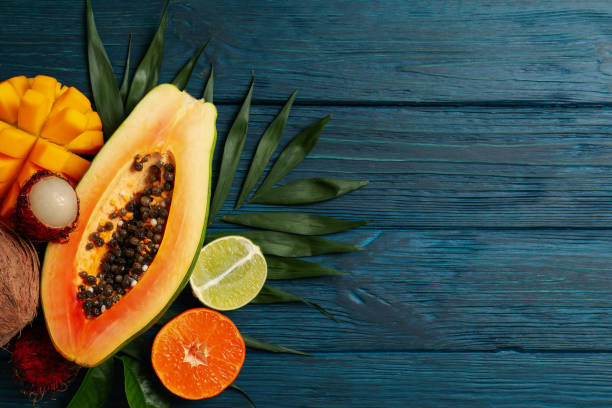 istock Fresh ripe exotic fruits on wooden background 1495106972