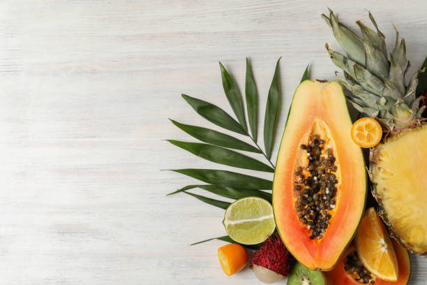 istock Exotic fruits on white wooden background, space for text 1495107645