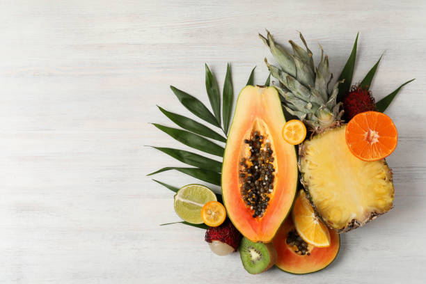 istock Exotic fruits on white wooden background, space for text 1495107678