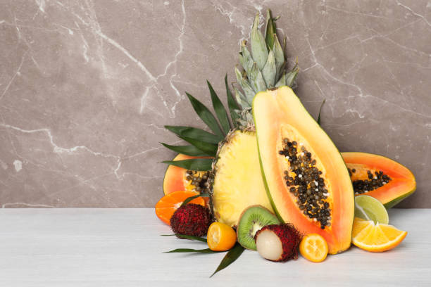 istock Ripe exotic fruits against gray textured background 1495108046