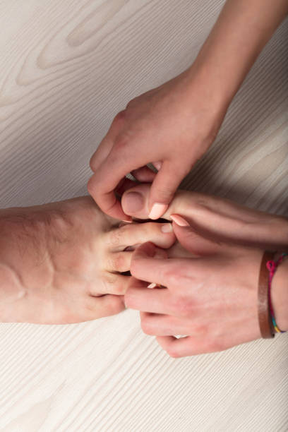 istock Pink-polished toes seek intimate connection, affection 1495108194