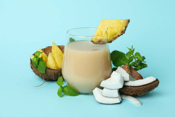 istock Pina colada cocktail and ingredients on blue background 1495108494