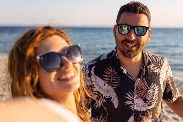 istock Young couple, taking selfie on the beach during sunset 1495112009