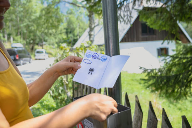Woman applying a special stamp after hiking up certain mountains