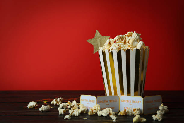 istock Paper box with popcorn, and tickets against red background 1495122149