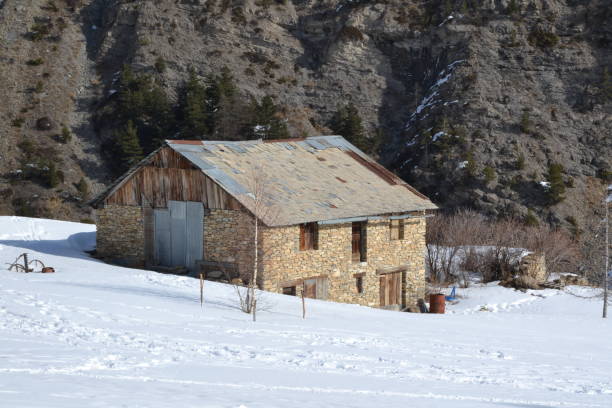 istock stone chalet in the middle of snow covered fields 1495122385