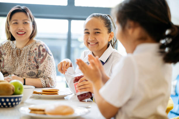 istock Mother and multiracial daughters enjoying breakfast together 1495122739