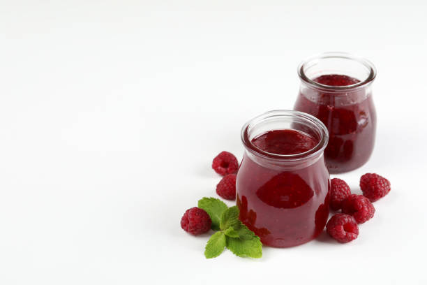 istock Jars of raspberry jam with ingredients on  white background 1495127550