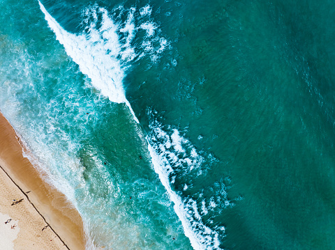 Aerial view of sea crashing waves White foaming waves on beach sand, Top view beach seascape view,Amazing nature sea ocean background