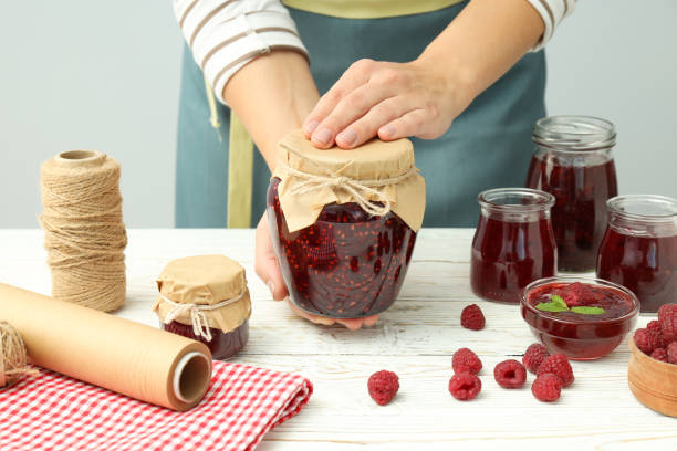istock Concept of cooking raspberry jam on white wooden table 1495127775