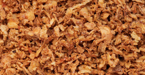 istock crispy onions. Traditional fried crispy onions backed in flour. selective focus. 1495130373