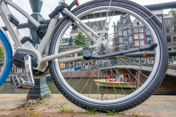 istock Amsterdam Canal Quay and Bicycle Wheel 1495130569