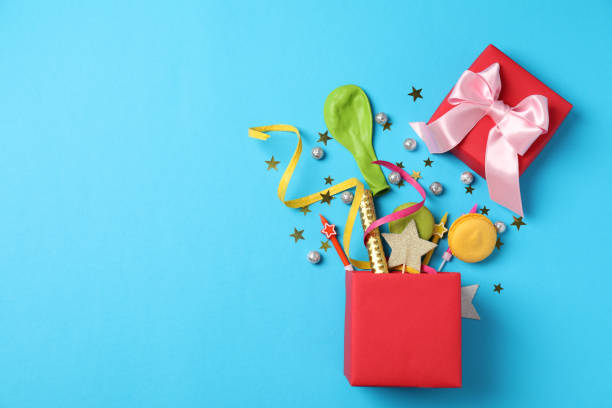 istock Gift box with Birthday accessories on blue background 1495131445