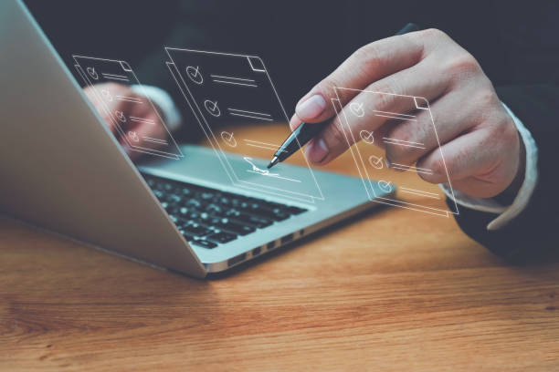 istock E-document management Paperless workplace, e-signing, Business people sign electronic documents on digital documents, electronic signature concept, paperless office, future business contract signing. 1495132442