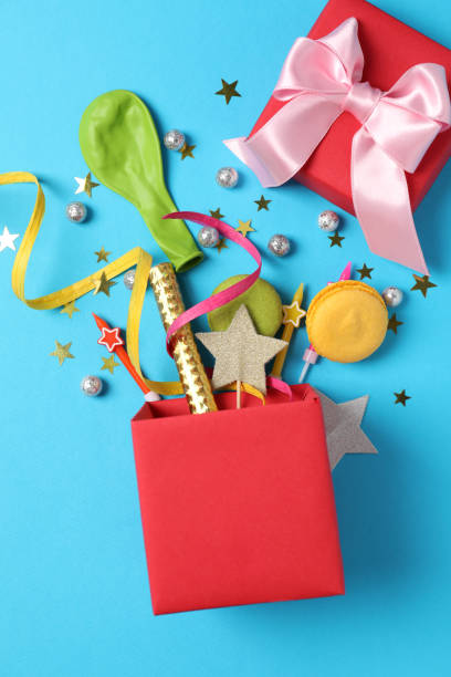 istock Gift box with Birthday accessories on blue background 1495132620