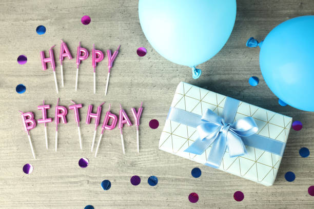 istock Birthday accessories on gray wooden table, top view 1495132696