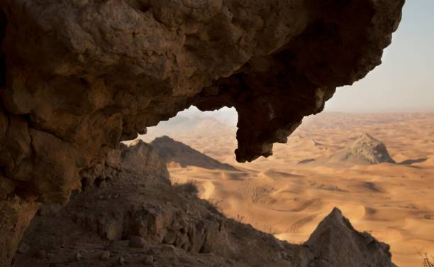 istock Rocky cliff with a sandy desert landscape in the background. 1495135379