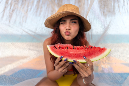 Young woman eating watermelon.