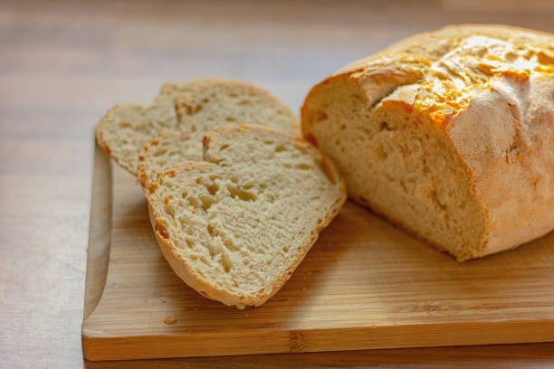 istock close up fresh white sliced bread on wooden table in kitchen 1495138149