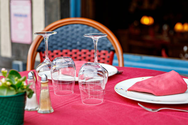 istock Empty glasses set in restaurant - Dinner table outdoors in France. 1495138159