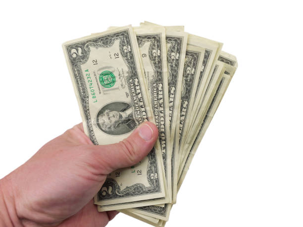 istock Man Holding Numerous Two Dollar Bills 1495139206