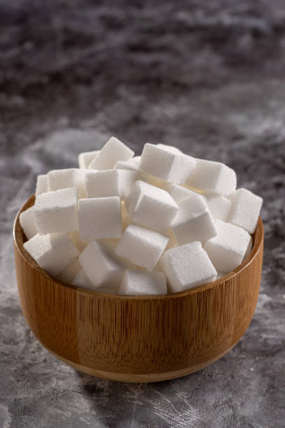 istock White sugar cubes in wooden bowl. 1495139319