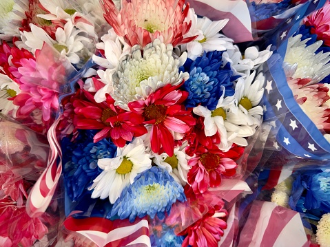 Bundles of red white and blue wrapped floral bouquets. Full frame patriotic background