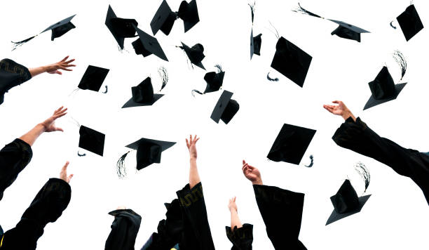 istock Graduating students hands throwing graduation caps on white background 1495139605