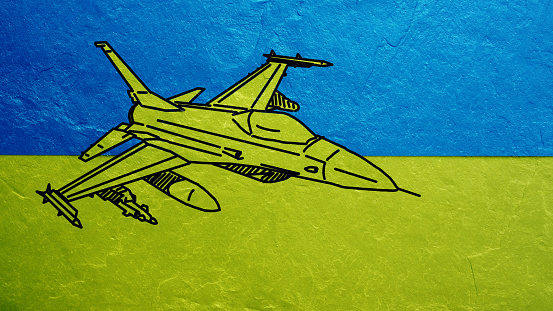 Picture of air fighter F-16 on the flag of Ukraine on a concrete wall