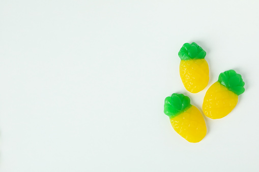 Gummy candies on white background, space for text.